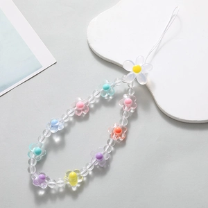 Colorful acrylic flower beaded phone strap with pastel beads and white lanyard on a coaster