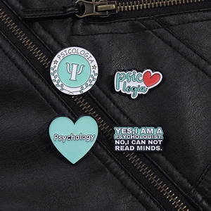 Detailed close-up of psychology enamel pins pinned on a black leather jacket