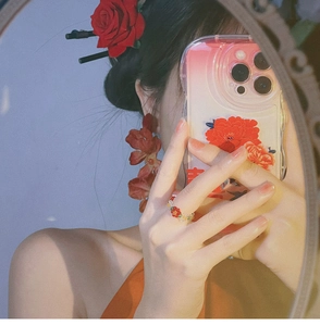 Mirror selfie showing vintage red rose earrings and beaded floral ring accessories