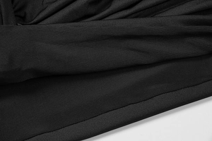 Close-up of black ruched dress fabric showing detailed texture and stitching quality