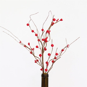 Artificial red berry stems for Christmas and New Year home decor in a glass vase