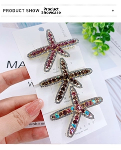 Macro detail of rhinestone starfish hair clips set in pink, amber and multicolor