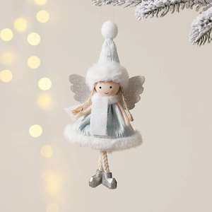 Blue plush Christmas angel doll ornament with silver wings hanging on a pine tree branch
