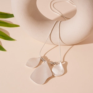 Detail of silver long sweater chain with matte metallic irregular petal pendants and beads