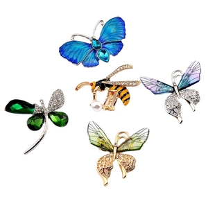 Elegant insect brooches featuring crystal dragonflies and enamel butterflies on white base