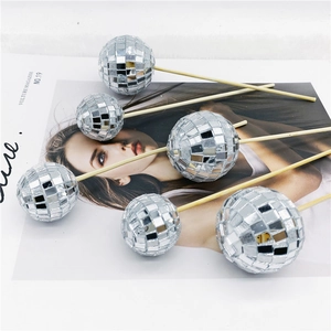 Detailed view of silver disco ball cake toppers with reflective mirror tiles on wooden sticks