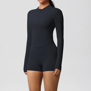 Front view of black slim fit yoga set with zip-up long sleeve top and high waist shorts