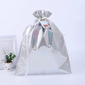Detailed view of silver laser drawstring gift bag with metallic grid texture and ribbon