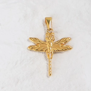 Detail of a 24K gold plated dragonfly pendant with intricate wings and metal connector