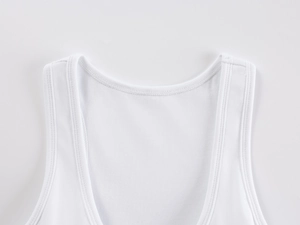 Close-up of white ribbed knit sports tank top showing scoop neckline and wide straps