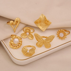 Set of 7 gold-toned adjustable stainless steel rings with pearls and butterfly motifs