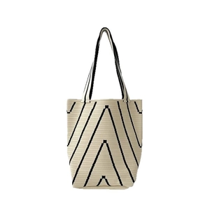 Knitted tote bag with black V-shaped geometric wave patterns on beige background
