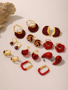 Detailed view of red enamel earrings set with 18k gold plating in vintage style