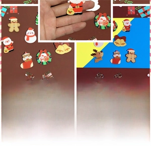Detail view of festive Christmas acrylic brooches with pins for backpacks and accessories