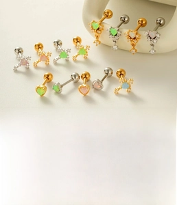 Close-up of heart opal and cross stud earrings made of titanium steel and copper