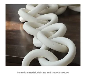 Close-up of matte white ceramic chain rings showing smooth and refined texture details