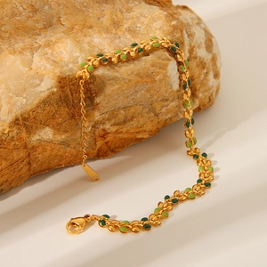 18K gold-plated stainless steel leaf bracelet with green enamel on a natural stone