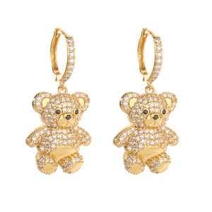 Detailed macro view of golden teddy bear hoop earrings with sparkling white cubic zirconia
