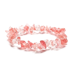 Macro shot of natural irregular rose quartz and clear crystal beaded handmade bracelet