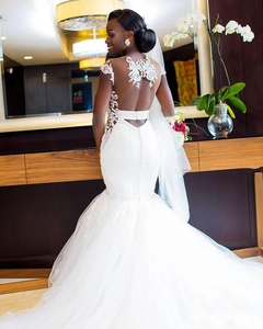 Exquisite back detail of mermaid wedding dress with lace appliques and button closures