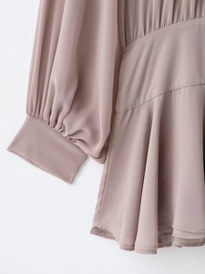 Detail of pink chiffon dress showing lantern sleeves and pleated waist stitching