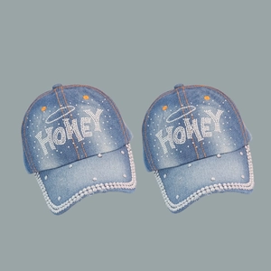 Light blue denim baseball cap with HONEY rhinestone lettering and pearl brim trim detail