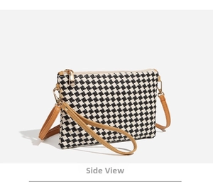 Detailed side view of black and white woven checkered crossbody bag with brown straps