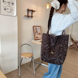 Leopard print tote bag shown on model highlighting its large capacity for daily commuting