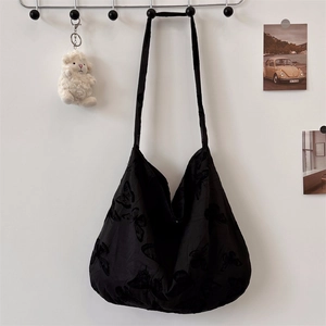 Detail of black lace butterfly hobo bag with large capacity and lightweight fabric texture