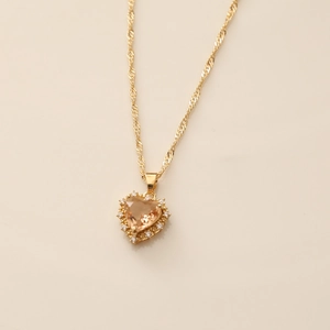 Close-up of gold heart necklace with champagne zircon and sparkling pavé setting details