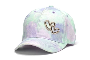 Detail of colorful tie-dye kids baseball cap featuring sparkling double heart rhinestones