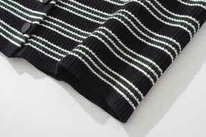 Detail of striped knit cardigan showing black buttons and ribbed hem texture