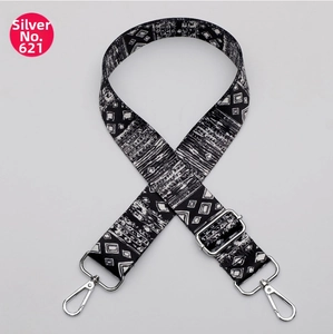 Close-up of ethnic geometric pattern webbing with silver adjustable metal hardware