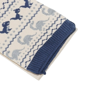 Detail of dinosaur jacquard knit patterns and ribbed edge on children scarf and sweater