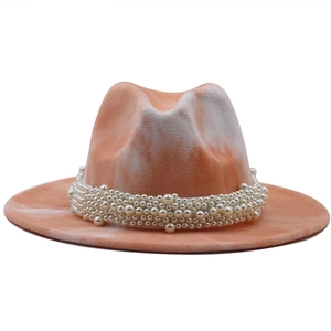 Detailed shot of two-tone orange and white wool fedora hat with pearl bead band