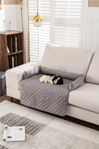 Detail of grey quilted water-resistant pet sofa protector mat with raised bolsters