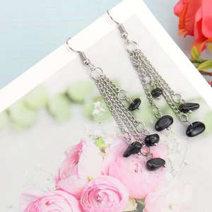 Detail of silver multi-layer chain tassel earrings with black natural crystal beads