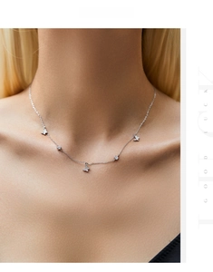 Macro shot of silver butterfly necklace with sparkling zircon pendants on a model