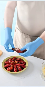 Food-grade blue nitrile gloves showing durable protection during seafood handling