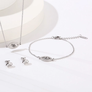 Silver evil eye jewelry set featuring sparkling necklace bracelet and stud earrings
