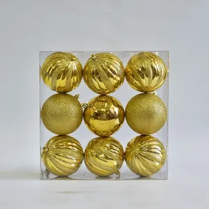 Detailed view of nine 10cm gold Christmas balls in various finishes and patterns