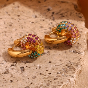 Macro view of gold-plated hoop earrings with micro-set rainbow colored crystals