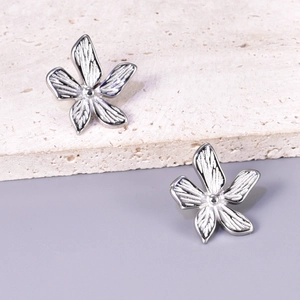 Silver flower stud earrings with brushed texture and petal design in 18k gold plating