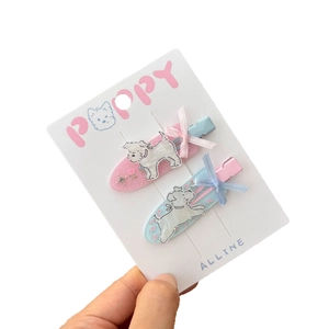 Set of two candy-colored hair clips with Westie dog motifs and cute ribbon bows