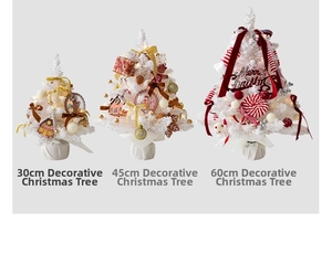Three sizes of decorated white Christmas trees with red ribbons and gingerbread ornaments
