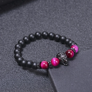 Wolf head beaded bracelet with black matte stones and magenta cat eye beads on dark base
