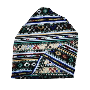 Detail of bohemian beanie showing colorful geometric knit patterns and rich textures