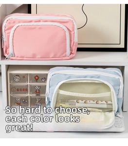 Detail of multi-layered fabric stationery bag featuring mesh pocket and dual zippers