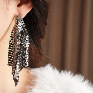 Close-up of gunmetal grey fringe earrings with triangle mesh on a female model