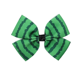 Close-up of a green watermelon striped bow hair clip with ribbed fabric texture